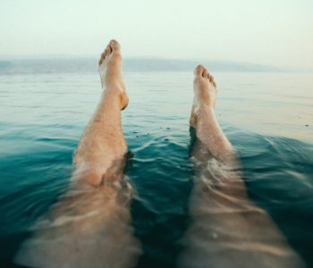 Woman in a lake, legs visible